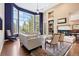 Bright living room with floor-to-ceiling windows, fireplace, hardwood floors, neutral furniture, and stylish decor at 5575 Jackpine Rd, Evergreen, CO 80439