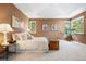 Bright main bedroom with fresh carpet, tray ceilings, and art to complement the space at 5575 Jackpine Rd, Evergreen, CO 80439