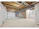 Unfinished basement featuring utilities and wood frame walls at 7360 Watercress Dr, Littleton, CO 80125