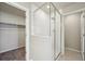 A view of the bathroom shower through a glass door, with a glimpse of the closet to the left at 7360 Watercress Dr, Littleton, CO 80125