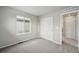 Carpeted bedroom features a window and double door closet at 7360 Watercress Dr, Littleton, CO 80125