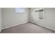 Bedroom featuring neutral carpet and two windows for natural light at 7360 Watercress Dr, Littleton, CO 80125