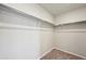 A walk-in closet featuring white shelving for organization and carpeted flooring at 7360 Watercress Dr, Littleton, CO 80125