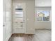 Bright entryway featuring a stylish front door with glass panels and wood-look flooring at 7360 Watercress Dr, Littleton, CO 80125