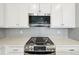 Modern kitchen features stainless steel gas range and subway tile backsplash at 7360 Watercress Dr, Littleton, CO 80125