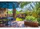 Enjoy the backyard view from the deck, featuring a dining table, landscaping and chicken coop at 310 Judson St, Longmont, CO 80501