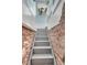 Basement stairs lead up to the first floor with painted walls and stone foundation at 310 Judson St, Longmont, CO 80501