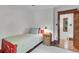 Small bedroom with hardwood floors features a decorative wood doorway and trim at 310 Judson St, Longmont, CO 80501
