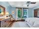 Light-filled bedroom with hardwood floors, two windows, and a vintage-style dresser at 310 Judson St, Longmont, CO 80501
