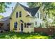 Charming yellow two-story home with a well-manicured lawn and inviting curb appeal at 310 Judson St, Longmont, CO 80501