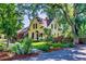 Charming two-story yellow house surrounded by mature trees and landscaping at 310 Judson St, Longmont, CO 80501