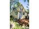 Charming yellow two-story home with a wood deck, purple doors and landscaped yard at 310 Judson St, Longmont, CO 80501