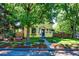 Charming yellow two-story home with lush landscaping, mature trees and inviting curb appeal at 310 Judson St, Longmont, CO 80501