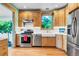 Bright kitchen features stainless steel appliances, light wood cabinets, and ample counter space at 310 Judson St, Longmont, CO 80501