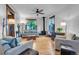 Bright living room featuring hardwood floors, a wood-burning stove, and comfortable seating at 310 Judson St, Longmont, CO 80501