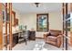 Well-lit office with dark wood trim, a view to the outdoors, and comfortable seating at 310 Judson St, Longmont, CO 80501