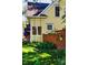 Side view of a charming yellow home with lush green grass and a wooden swing at 310 Judson St, Longmont, CO 80501