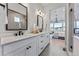 Elegant bathroom featuring double vanity sinks, a large mirror, and a glass-enclosed shower at 3394 Backdrop Ct, Castle Rock, CO 80108