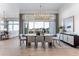 Bright dining room with a modern chandelier, large windows, and contemporary decor at 3394 Backdrop Ct, Castle Rock, CO 80108