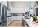 Well-lit kitchen featuring stainless steel appliances, white cabinets, and a functional kitchen island at 3394 Backdrop Ct, Castle Rock, CO 80108