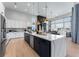 Modern kitchen with a two-tone island, stainless steel appliances, and open to living area at 3394 Backdrop Ct, Castle Rock, CO 80108