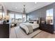 Spacious main bedroom with large windows, elegant chandelier, and sophisticated decor at 3394 Backdrop Ct, Castle Rock, CO 80108