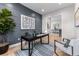 Modern home office with paneled accent wall, contemporary desk, and stylish decor at 3394 Backdrop Ct, Castle Rock, CO 80108