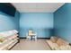 Bright playroom with table, chairs, shelving, and a blue accent wall at 3394 Backdrop Ct, Castle Rock, CO 80108