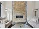 Close up of a stone fireplace with a linear firebox, hardwood floors and chairs at 350 15Th St, Boulder, CO 80302