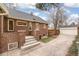 Brick home exterior featuring a spacious concrete driveway leading to a detached garage at 446 N Marion St, Denver, CO 80218