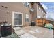 Cozy backyard patio with a grill, bordered by a wood fence, ideal for outdoor cooking and enjoyment at 371 Smith Cir, Erie, CO 80516