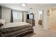 Relaxing bedroom with neutral tones, a carpet, and a connecting bathroom and closet at 371 Smith Cir, Erie, CO 80516