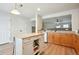 Updated kitchen features island, wood floors, wood cabinets, and modern stainless-steel appliances at 371 Smith Cir, Erie, CO 80516