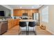 Contemporary kitchen with stainless-steel appliances, wood cabinets, and an island with bar seating at 371 Smith Cir, Erie, CO 80516