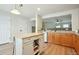 Bright kitchen features an island, wood floors, wood cabinets, and updated appliances at 371 Smith Cir, Erie, CO 80516