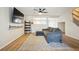 Bright living room with stylish furniture, wood flooring, and an open layout to the kitchen at 371 Smith Cir, Erie, CO 80516
