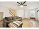 Relaxing living area featuring hardwood floors, a cozy sofa, and a neutral color palette at 371 Smith Cir, Erie, CO 80516