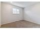 Well-lit bedroom features neutral tones, a window with blinds and soft carpeting, offering a blank canvas at 6650 E Arizona Ave # 154, Denver, CO 80224