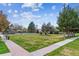 Inviting outdoor common area with lush green lawn, trees and a pool with pergola, creating a perfect leisure space at 6650 E Arizona Ave # 154, Denver, CO 80224