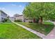 Well-maintained condo building with lush green lawn, showcasing the property's curb appeal and landscaped surroundings at 6650 E Arizona Ave # 154, Denver, CO 80224