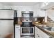 Efficient kitchen with stainless steel appliances, white cabinetry, and practical countertops at 6650 E Arizona Ave # 154, Denver, CO 80224
