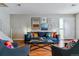 Inviting living room featuring a comfortable sofa, stylish decor, and hardwood floors with ample natural light at 6650 E Arizona Ave # 154, Denver, CO 80224