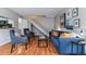 Well-lit living room featuring modern decor, hardwood floors, and open staircase nearby at 6650 E Arizona Ave # 154, Denver, CO 80224
