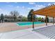 Beautiful community pool with a wooden pergola, surrounded by well-maintained landscaping and sunny skies at 6650 E Arizona Ave # 154, Denver, CO 80224