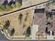 Bird's eye view of a home showcasing its roof, driveway, and expansive yard with trees at 24269 E Arapahoe Pl, Aurora, CO 80016
