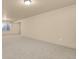 Unfurnished carpeted basement with natural light, flush mount lighting, and neutral paint at 24269 E Arapahoe Pl, Aurora, CO 80016