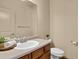 Bathroom with a sink, toilet, mirror, and neutral-toned walls at 24269 E Arapahoe Pl, Aurora, CO 80016