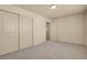 Bedroom with double door closet, carpet and neutral walls with views to another room through an open door at 24269 E Arapahoe Pl, Aurora, CO 80016