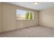 Bedroom featuring neutral carpet and a large window with blinds at 24269 E Arapahoe Pl, Aurora, CO 80016