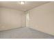 Bedroom with neutral colored walls and carpet with a partially open door leading to another room at 24269 E Arapahoe Pl, Aurora, CO 80016